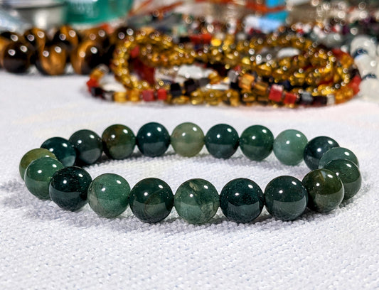 This is the main picture of the Moss Agate bracelet.   It is placed on a white surface.  The Moss Agate beads illustrate many colors of green.  It is excellent quality. 