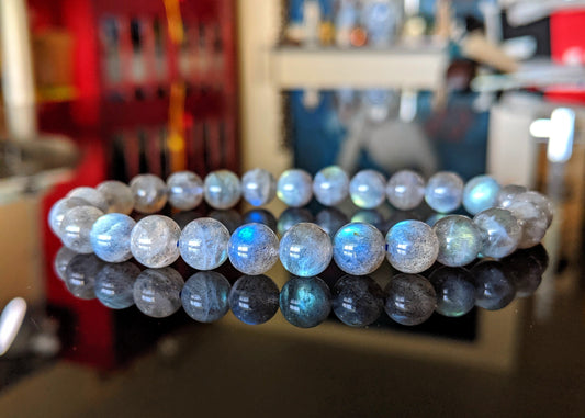 This is the main picture for the Labradorite 8mm size bead bracelet.  The bracelet is disp;layed on a black flat surface.  It is brilliant with lots of blue flash on the beads.  It is a top quality item. 